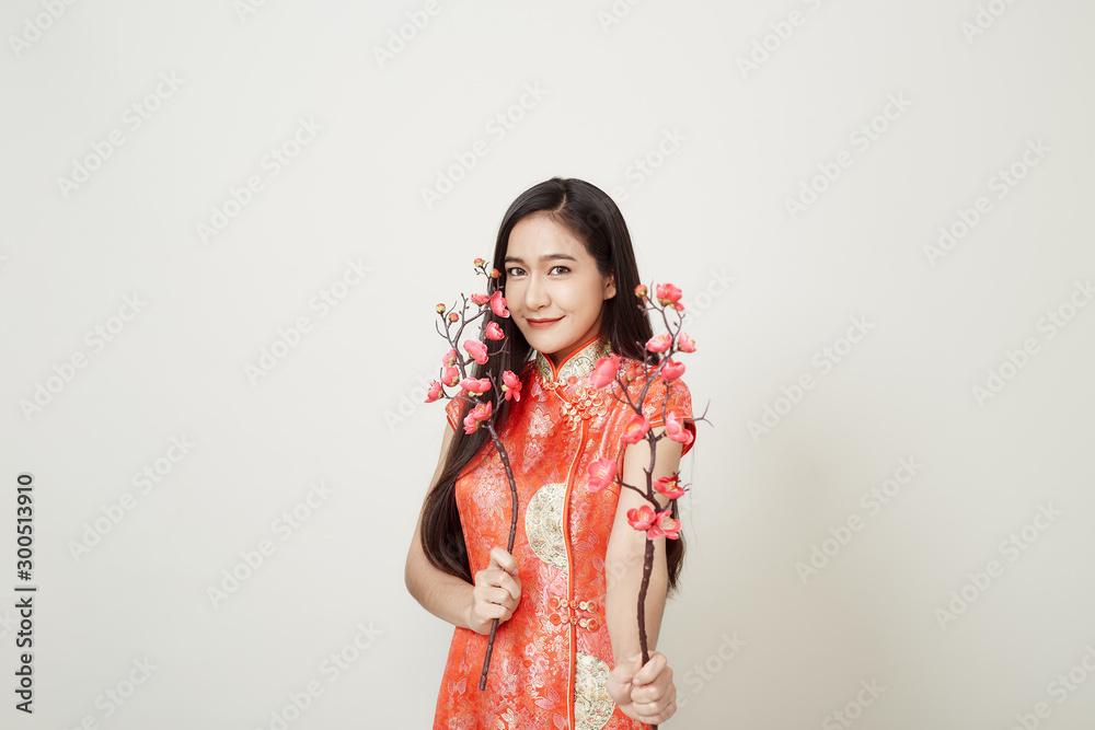 Woman in traditional chinese red dress with plum flowers Woman in traditional chinese red dress with plum flowers