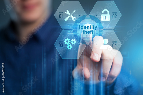 Business, Technology, Internet and network concept. Young businessman working on a virtual screen of the future and sees the inscription:Identity theft .