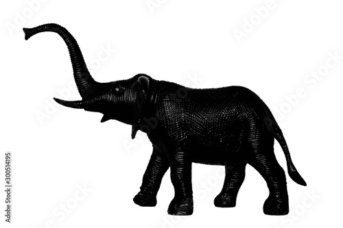 Black silhouette of elephant with trunk raised up on edge of top of cliff howl on white background. Isolated. © andreynov