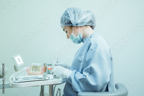 Portrait assistant dentist cleaning dental tools