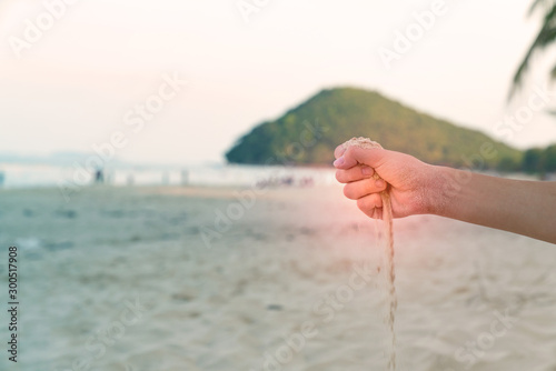 Sand in hand with sandy floor background