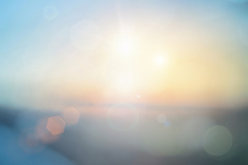 Natural background blurring warm colors and bright sun light. Bokeh or Christmas background Green Energy at sky sunny color orange light patterns plain abstract flare evening clouds blur.