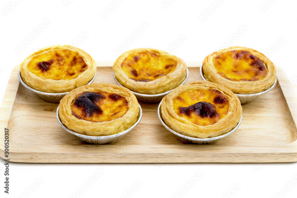 egg tart in aluminum foil cup isolated on white background egg tart in aluminum foil cup isolated on white background