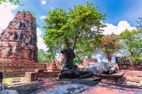 Obraz na płótnie Headless Buddha sits in the center of crumbling structures at the ancient historic city of Ayutthaya w salonie