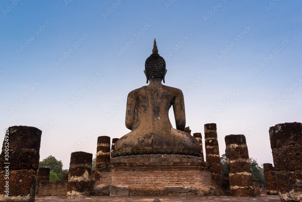 Fototapeta premium Buddha statue with ruined temple