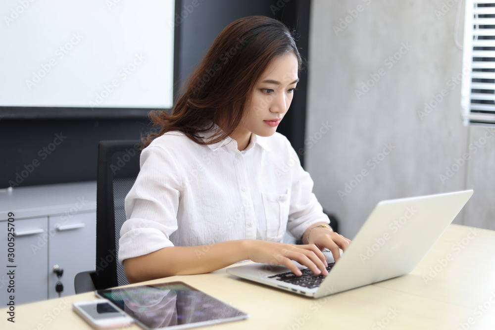 Asian business women using notebook and serious and headache for working Asian business women using notebook and serious and headache for working