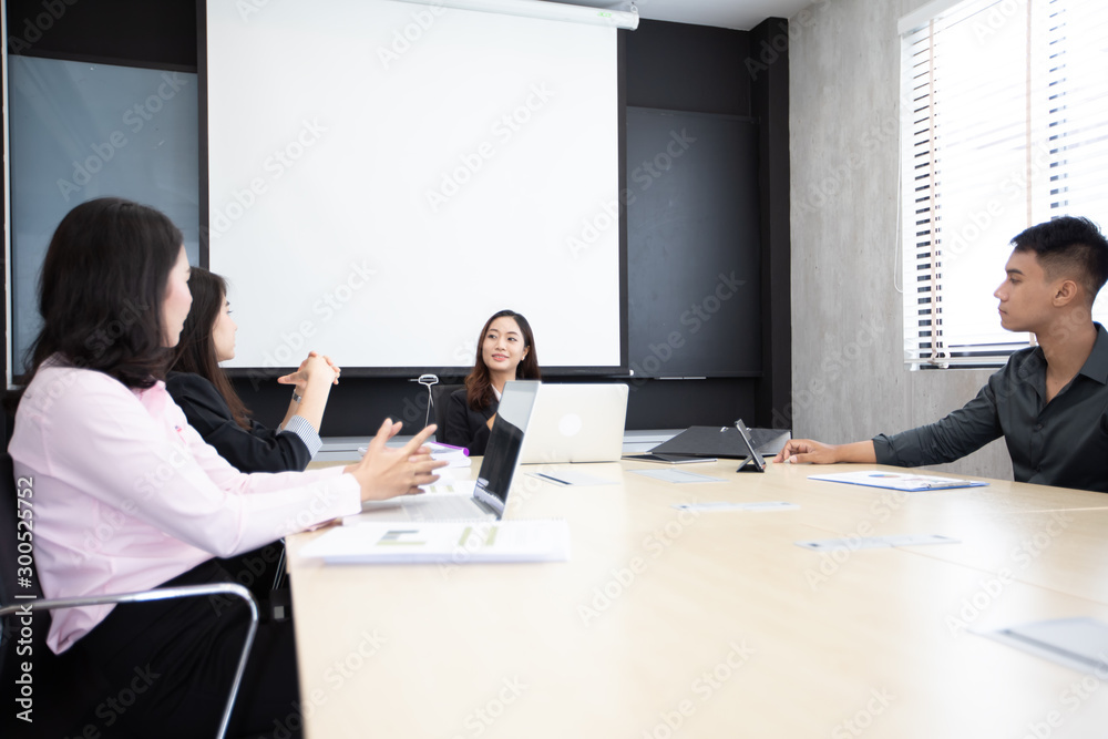 Asian businessmen and group using notebook for meeting serious about the work Asian businessmen and group using notebook for meeting serious about the work