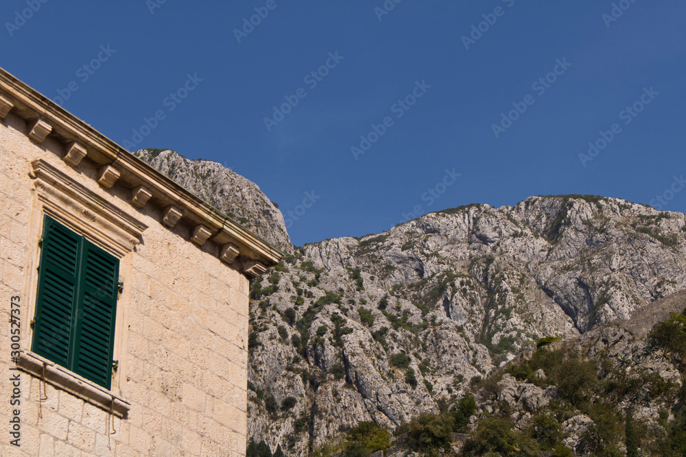 The building in the old town on the background of blue sky. Cator. Old town. Montenegro. - obrazy, fototapety, plakaty 