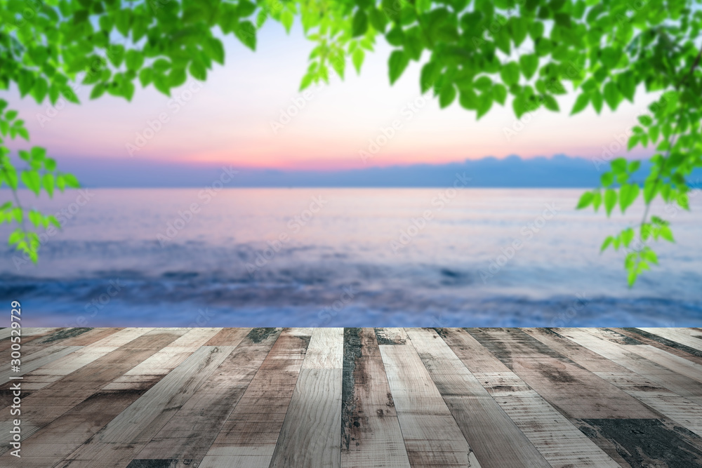 Fototapeta premium summer sea with green leaves pattern at sunset and copy space,sky relaxing concept,beautiful tropical background for travel landscape