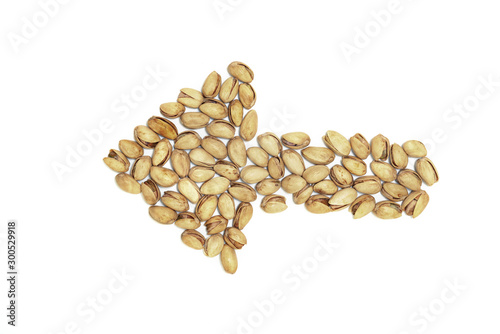 Closeup pistachios nut dry roasted and salted as arrow shape isolated on white background