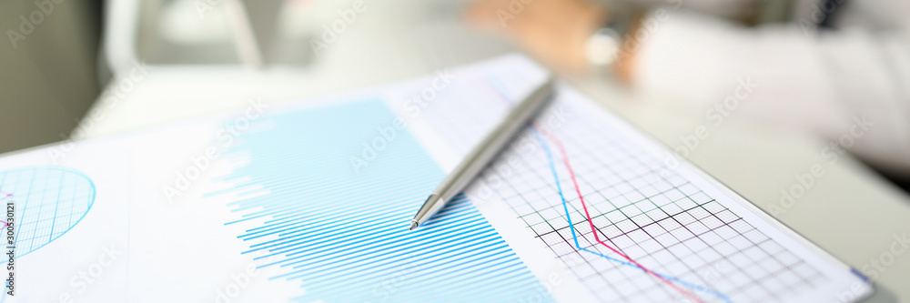 Silver pen lies on paper documents with color Silver pen lies on paper documents with color