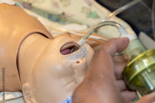 Neonatal reanimation medical instruccion with a baby mannequin or model. Orotraqueal tube and pulmonary ventilation. Team work concept. Neonatology. 