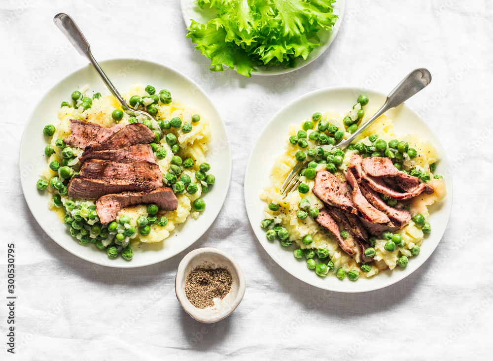 Beef steak with mashed potatoes and creamy green peas sauce on light background, top view Beef steak with mashed potatoes and creamy green peas sauce on light background, top view