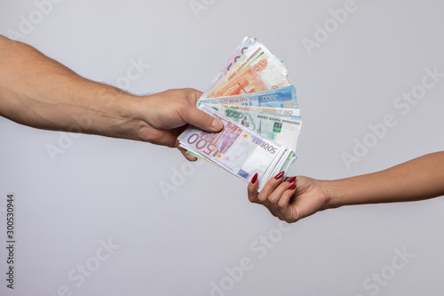 a man hands a beautiful girl money