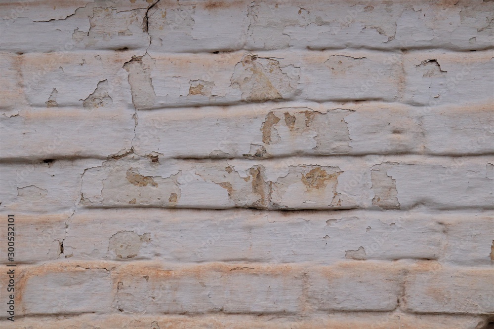 Brickwork with peeling gray paint. Brickwork with peeling gray paint.