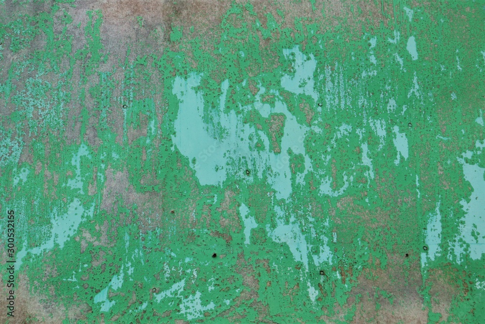 Surface with peeling green paint.