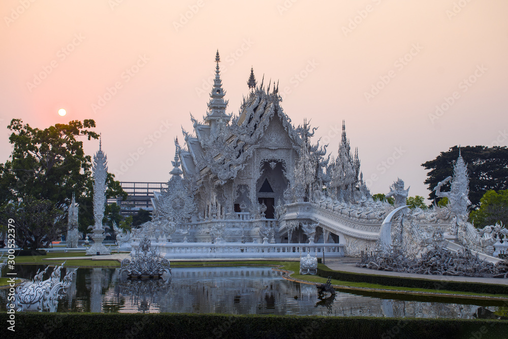 Fototapeta premium Wat Rong Khun Temple (White temple) during sunet at dusk in Chiangrai province, Thailand.