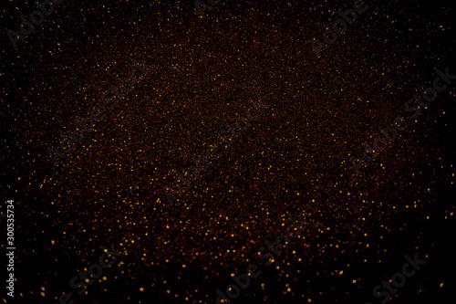 Twinkling golden glitter falling gold background