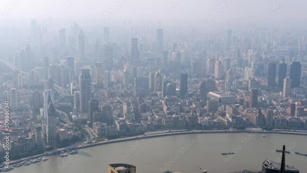Time lapse of shanghai bund, aerial view of bund skyline in foggy and air polluted day, ships sailing on huangpu river and busy traffic on road, 4k Version. Time lapse of shanghai bund, aerial view of bund skyline in foggy and air polluted day, ships sailing on huangpu river and busy traffic on road, 4k Version.