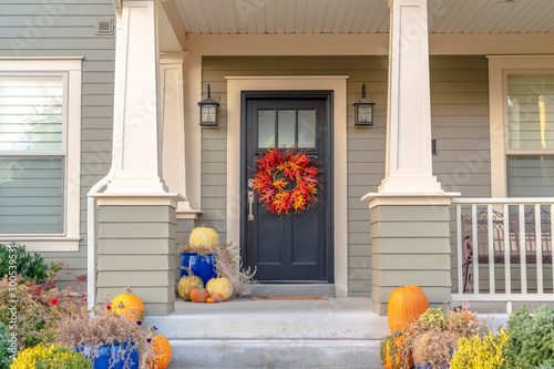 Fényképezés Colorful autumn wreath hanging on a front door