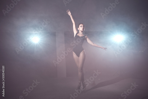 Girl posing in bodysuit and Pointe shoes in smoke © cvet