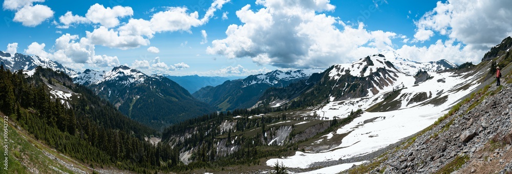 Fototapeta premium Panoramic view of snowcapped mountains and valley landscape with blue sky and clouds. Mt Shuksan, Mt Baker, Washington, USA