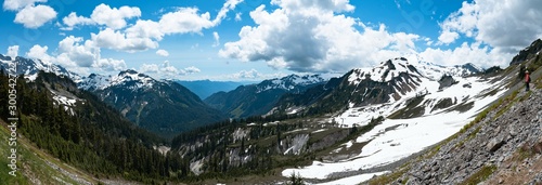 Panoramic view of snowcapped mountains and valley landscape with blue sky and clouds. Mt Shuksan, Mt Baker, Washington, USA