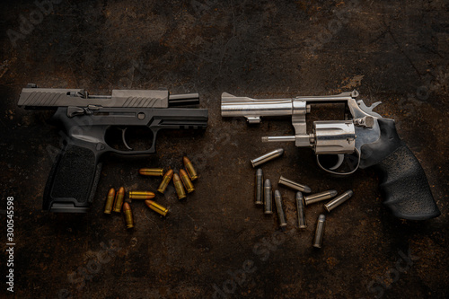 Guns and ammunition placed in a wooden table,Short guns and ammunition placed on a black background table,Guns and ammunition are ready to use. Noisy weapon