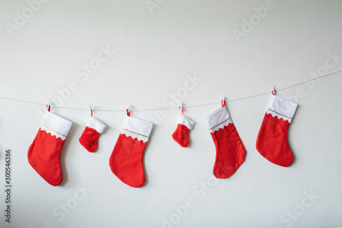 Christmas socks decoration toy hanging against wall for Christmas day on white wall background