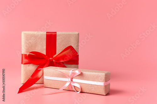 Wrapped presents on a pink background with copy space.