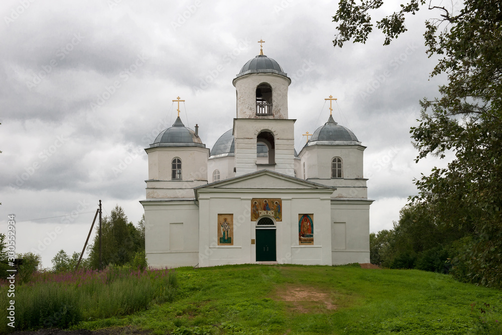 Orthodox church with frescoes on the wall in rainy weather