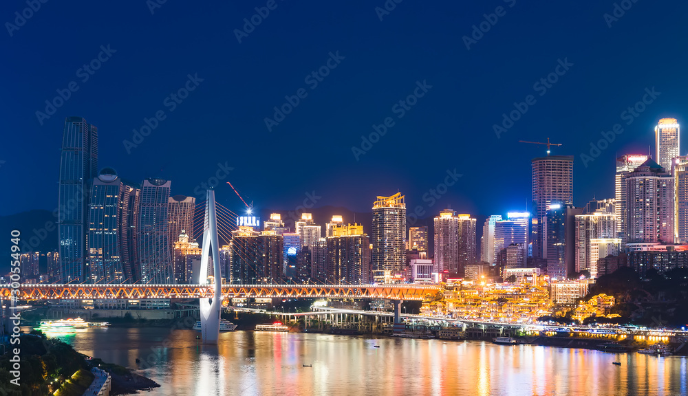 chongqing city skyline at night, with bridge and river.