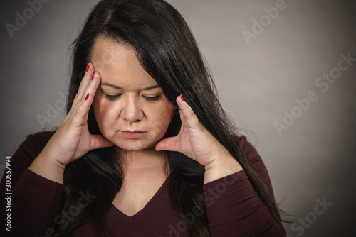 Worried woman having painfull headache © Voyagerix