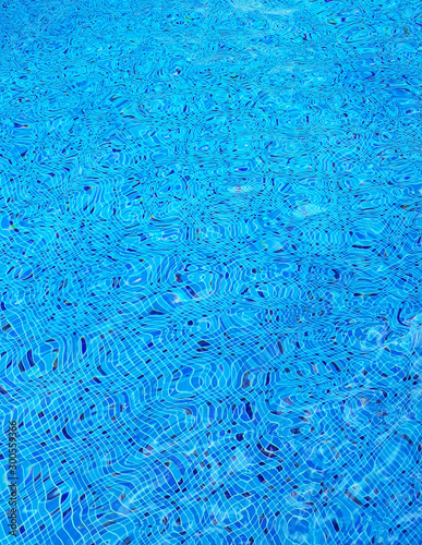 Swimming pool blue water surface texture.