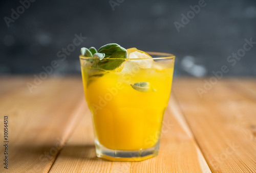 Sweet old-fashioned cocktail with orange and sage. Selective focus. Shallow depth of field.