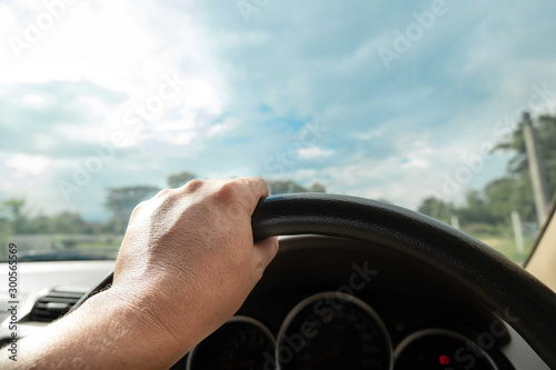 Hands driving a car in home town, safety drive and car insurance concept