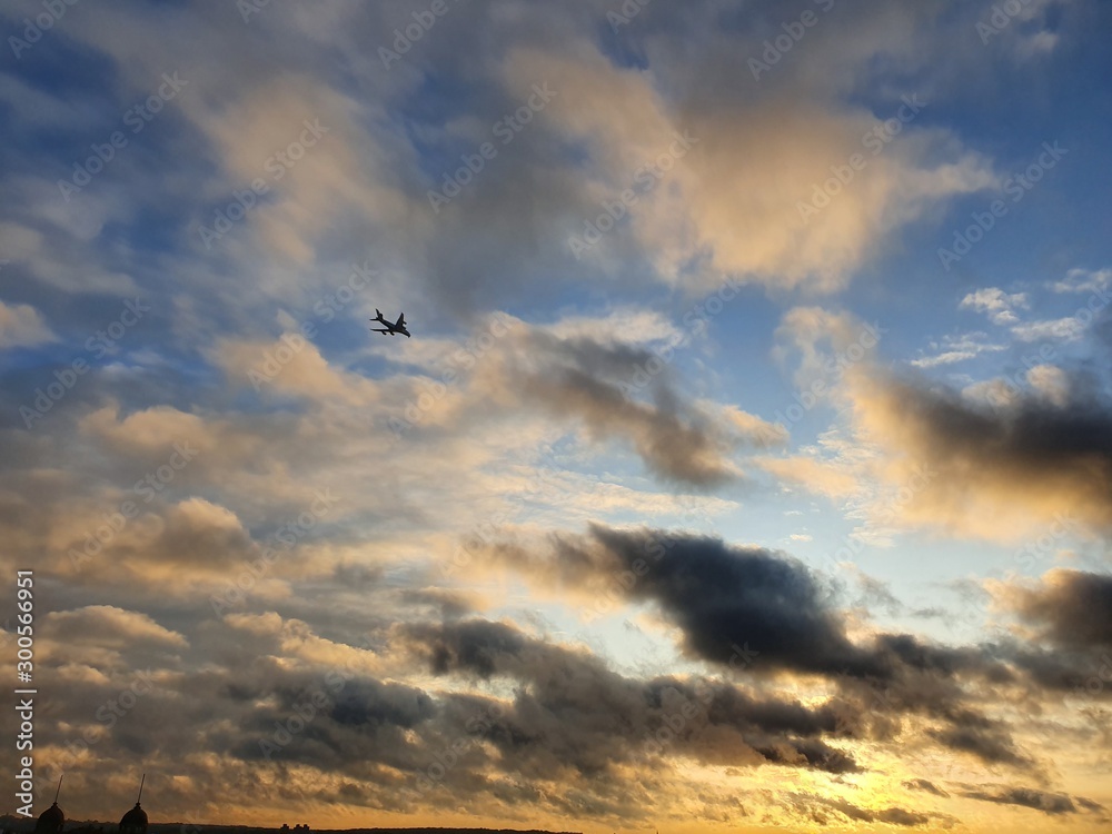 Sunset and airplane silhouette in the sky