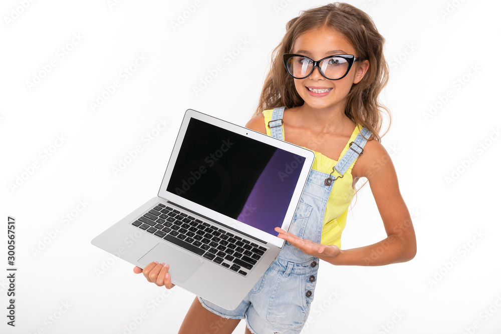 Young caucasian girl stands with the laptop and smiles Young caucasian girl stands with the laptop and smiles