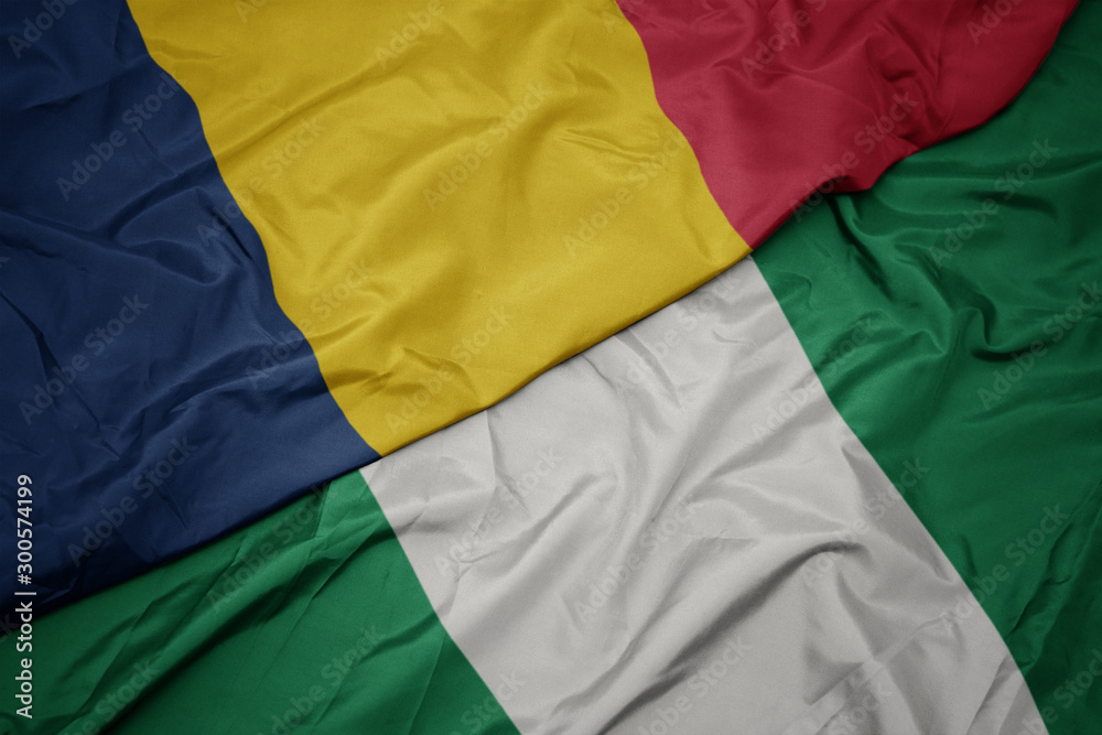 waving colorful flag of nigeria and national flag of chad. waving colorful flag of nigeria and national flag of chad.