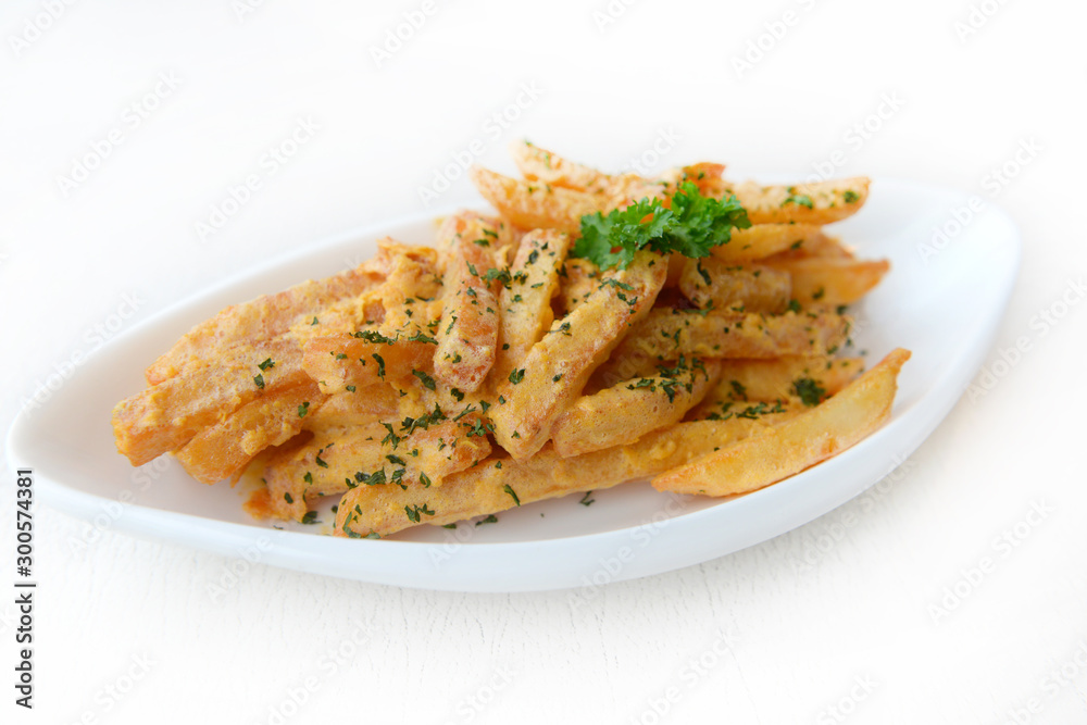 French fries seasoned with Salted Egg on the white plate. French fries seasoned with Salted Egg on the white plate.