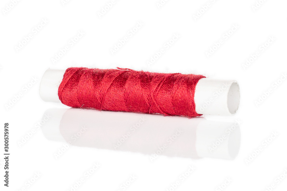 One whole red sewing thread spool isolated on white background One whole red sewing thread spool isolated on white background