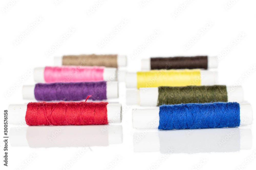 Group of eight whole sewing thread spool in row isolated on white background Group of eight whole sewing thread spool in row isolated on white background