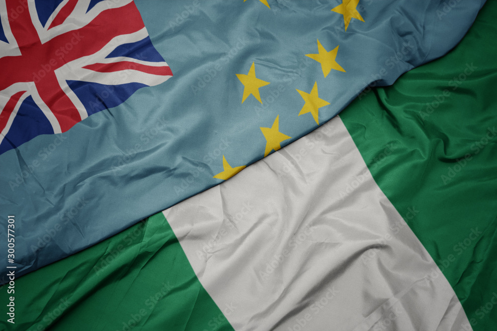 waving colorful flag of nigeria and national flag of Tuvalu . waving colorful flag of nigeria and national flag of Tuvalu .