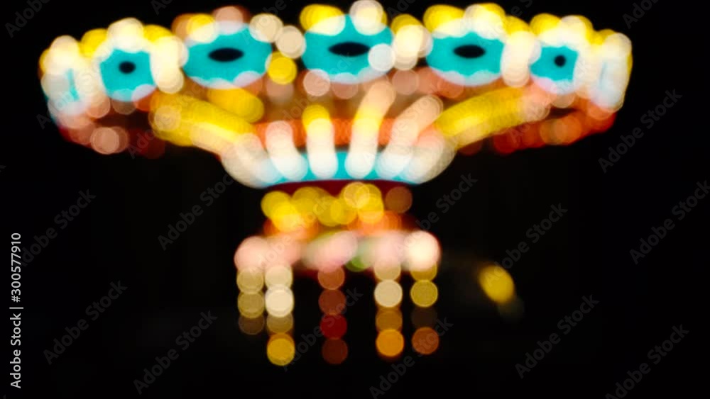 Luna park. Blurry image of moving carousel on dark. Black background. Luna park. Blurry image of moving carousel on dark. Black background.