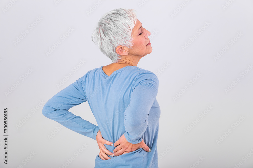 Matur Woman suffering from lower back pain. Mature woman resting with back pain. Female lower back pain. Senior woman injury suffering from backache - obrazy, fototapety, plakaty 