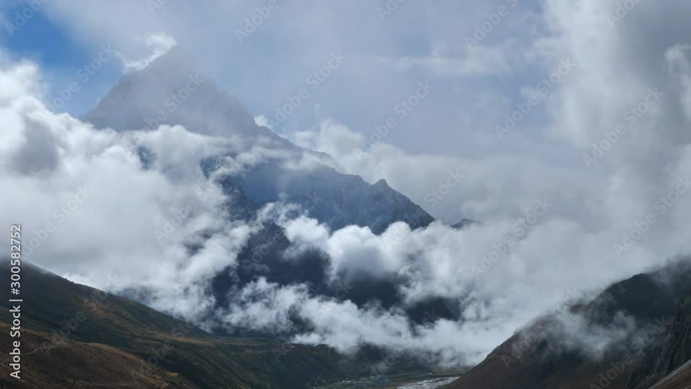 Eagle flies in the clouds against the backdrop of snowy mountains of Nepal, handheld shot Eagle flies in the clouds against the backdrop of snowy mountains of Nepal, handheld shot