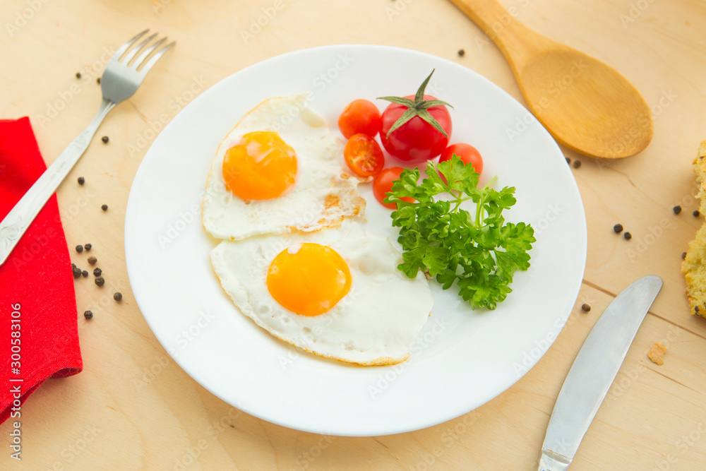 Fried eggs with white bread on plate on wooden table Fried eggs with white bread on plate on wooden table