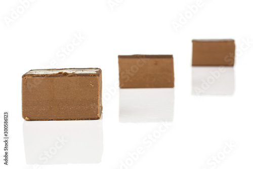 Group of three whole sweet brown viennese nougat placed diagonally isolated on white background