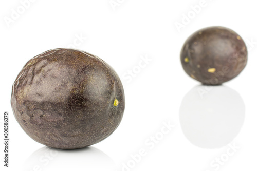 Group of two whole sweet dark purple passion fruit isolated on white background