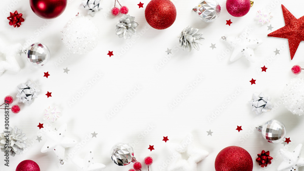 Christmas frame of red and silver decoration elements on white background top view. Xmas greeting card mockup, winter holidays banner template. Christmas frame of red and silver decoration elements on white background top view. Xmas greeting card mockup, winter holidays banner template.